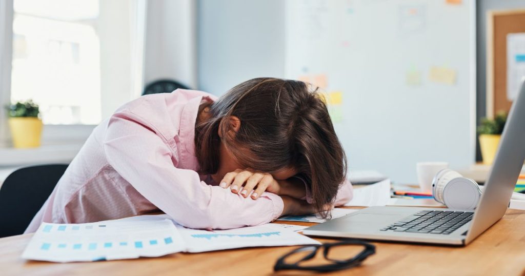Tired woman sleeping at her desk