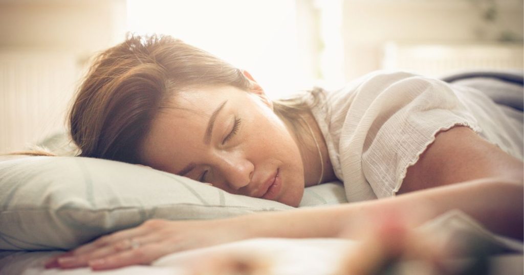 Woman sleeping on organic latex and natural fibre pillow