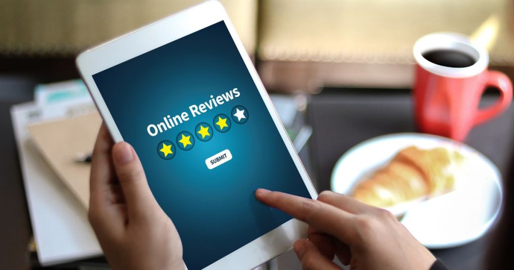 Person reading online reviews while shopping for a mattress online.