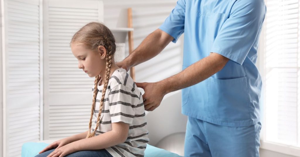 Girl receiving physio for her back.